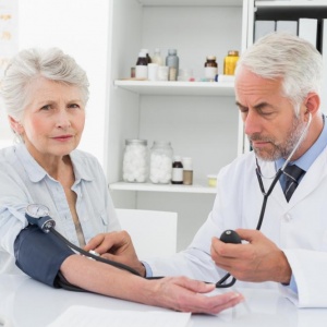 doctor-taking-blood-pressure-of-his-retired-patient doctor-taking-blood-pressure-of-his-retired-patient