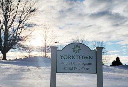 YRNC---Outside-Snow-with-Sign_c