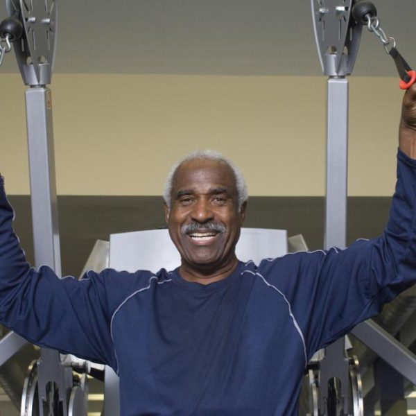 portrait-of-happy-senior-man-exercising-in-gym